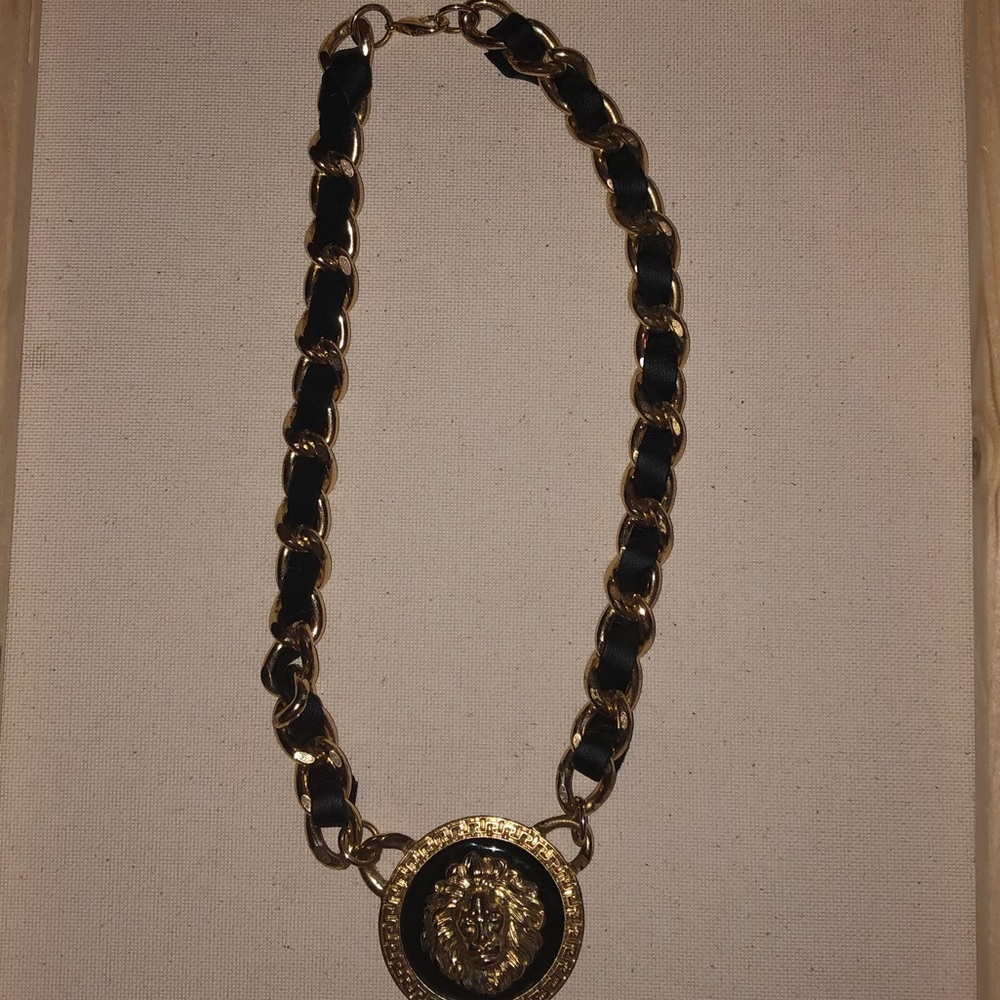 thick gold and black chain with lion pendant